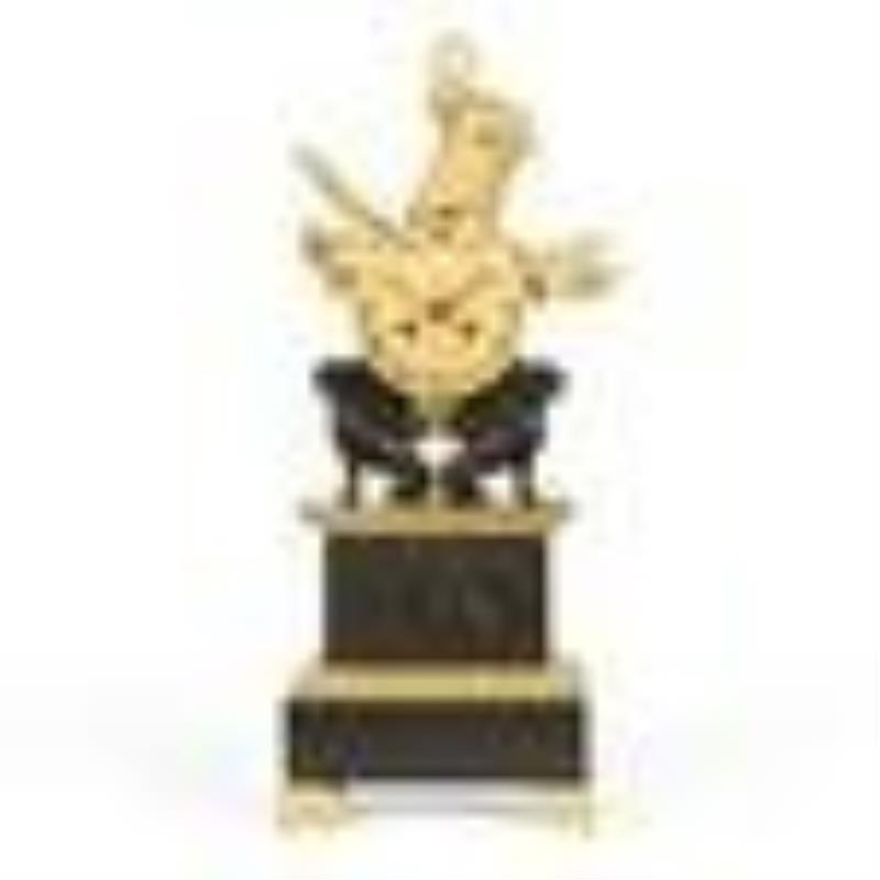 A Charles X bronze military trophy mantel clock