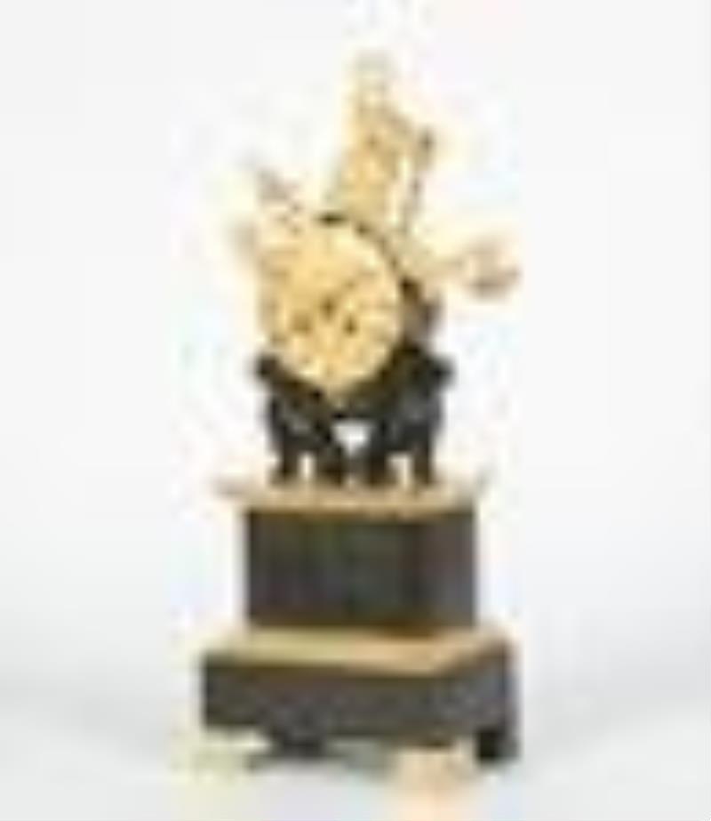 A Charles X bronze military trophy mantel clock