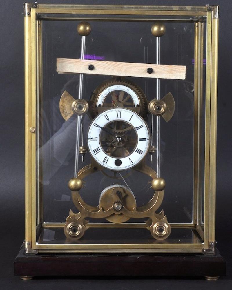 A GRASSHOPPER BLACK SKELETON CLOCK in a glass case. 17