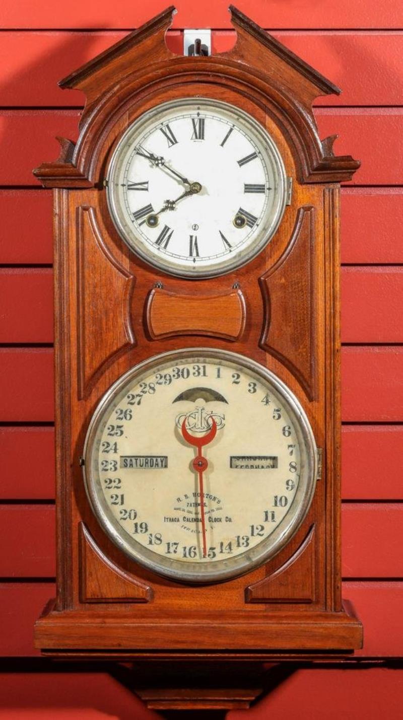 AN ITHACA NO. 6 HANGING LIBRARY WALNUT CALENDAR CLOCK