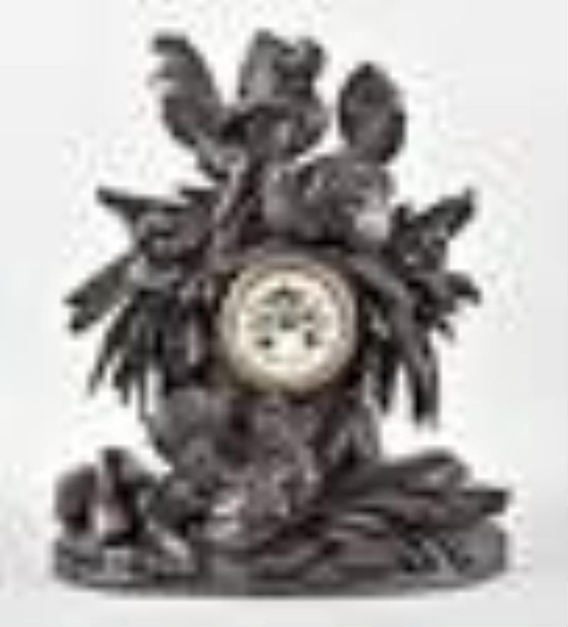 Carved Black Forest mantel clock with a French movement