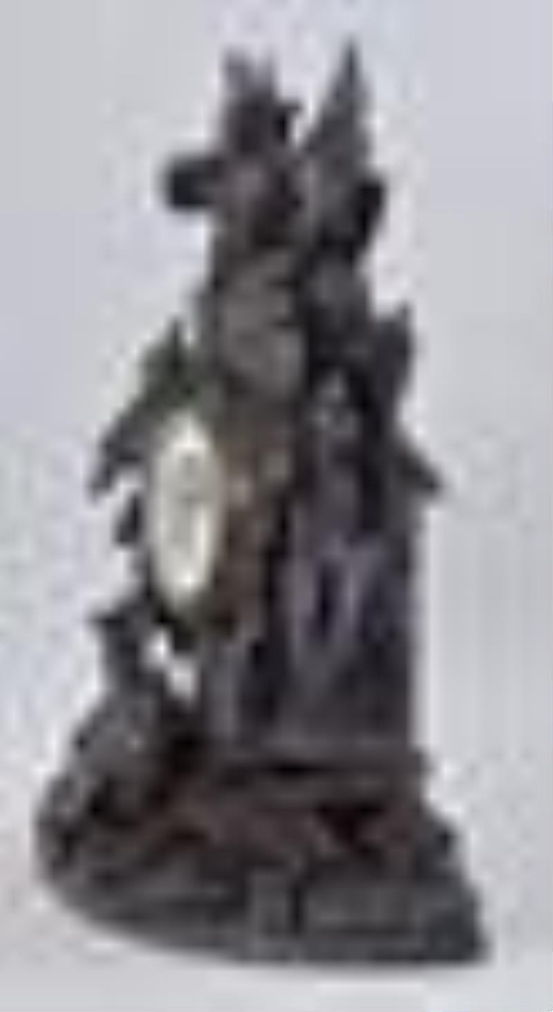 Carved Black Forest mantel clock with a French movement