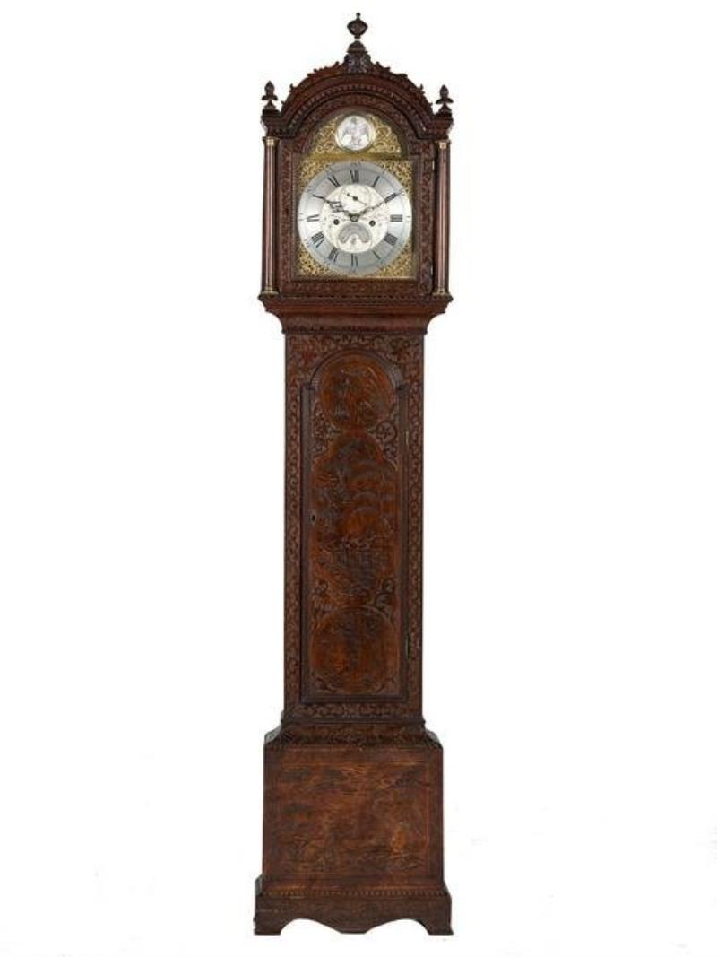 An English Tall Case Clock with Finely Carved Oak Case