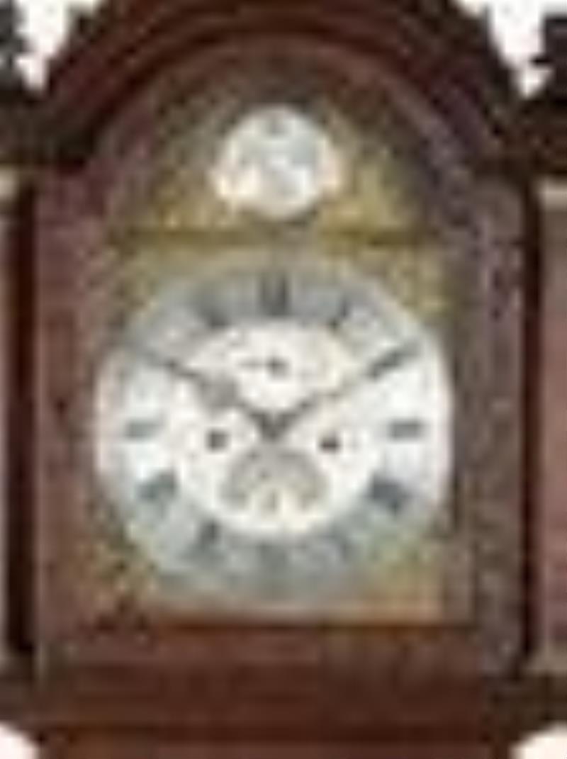 An English Tall Case Clock with Finely Carved Oak Case