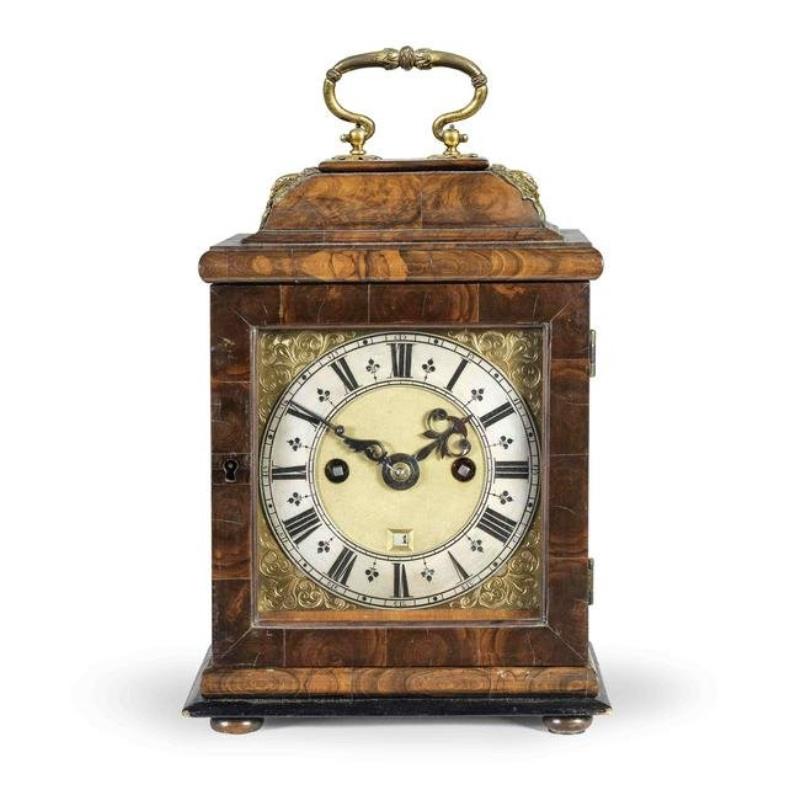 A miniature olive-wood veneered striking table clock