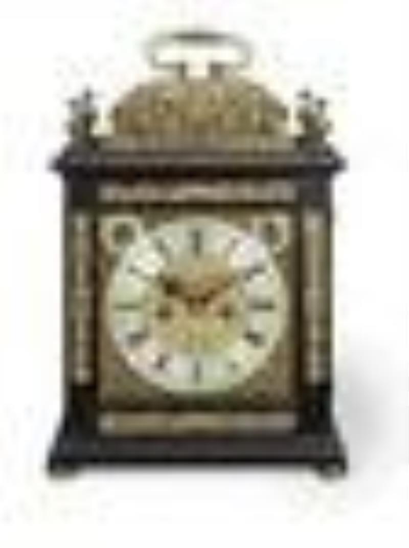 A late 17th century ebony basket top table clock with