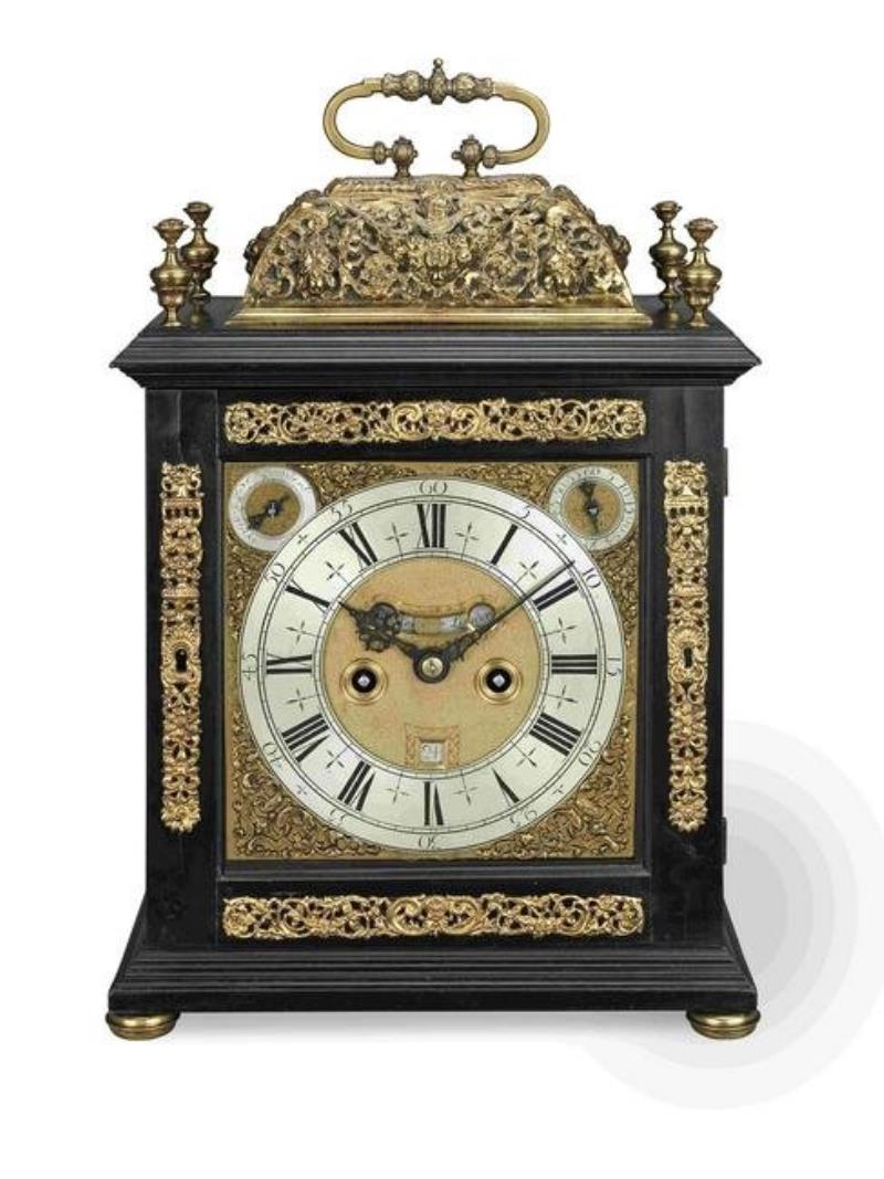 A late 17th century ebony basket top table clock with