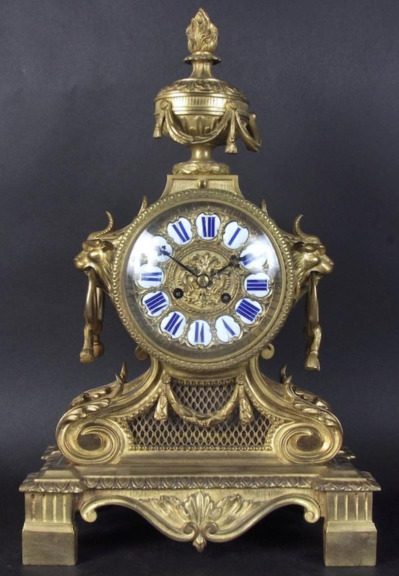 A 19TH CENTURY FRENCH ORMOLU CLOCK WITH URN FINIAL,