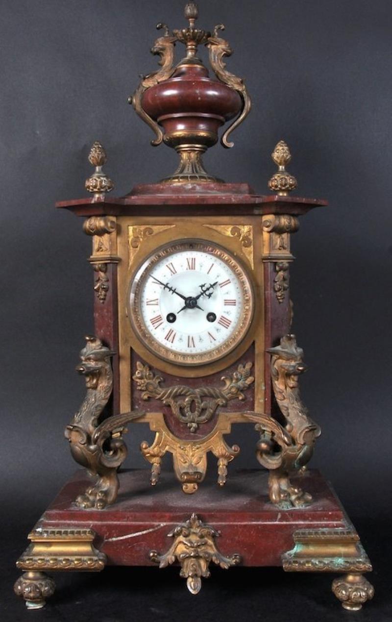 A 19TH CENTURY FRENCH MARBLE AND ORMOLU CLOCK with urn