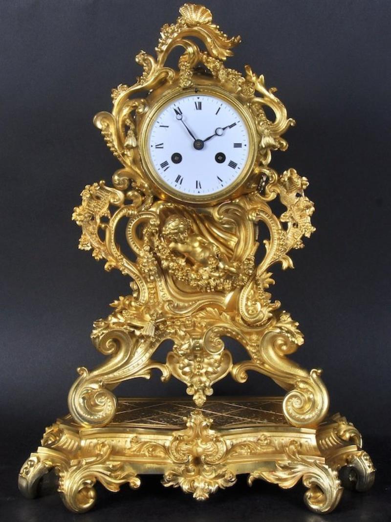 A 19TH CENTURY FRENCH ORMOLU CLOCK, the case with