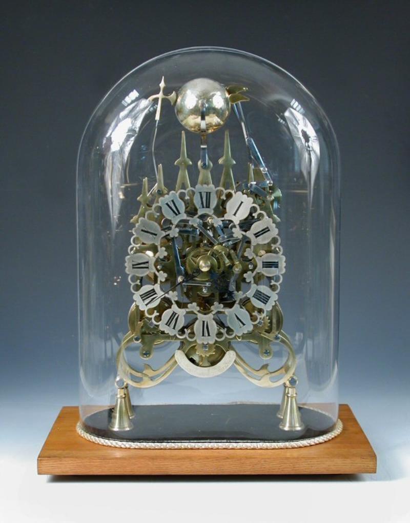 A 20TH CENTURY TRIPLE FUSEE SKELETON CLOCK