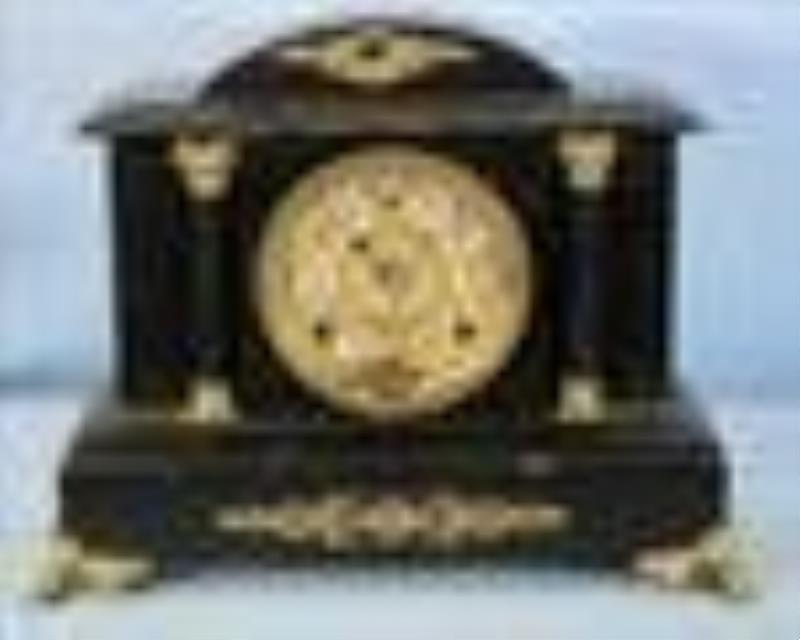 Ebonized wood mantle clock with gold trim by Gilbert