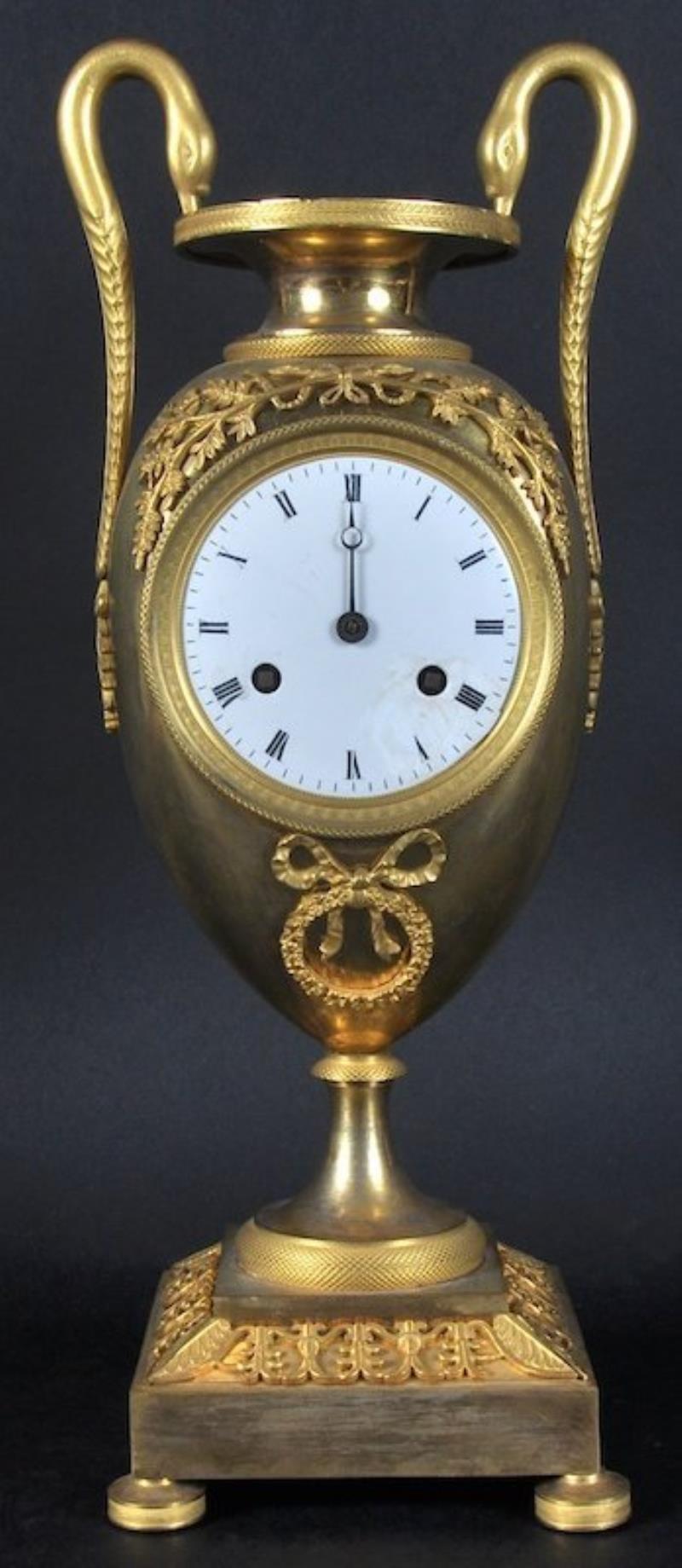 A GOOD EMPIRE ORMOLU URN-SHAPED TWO-HANDLED CLOCK, with