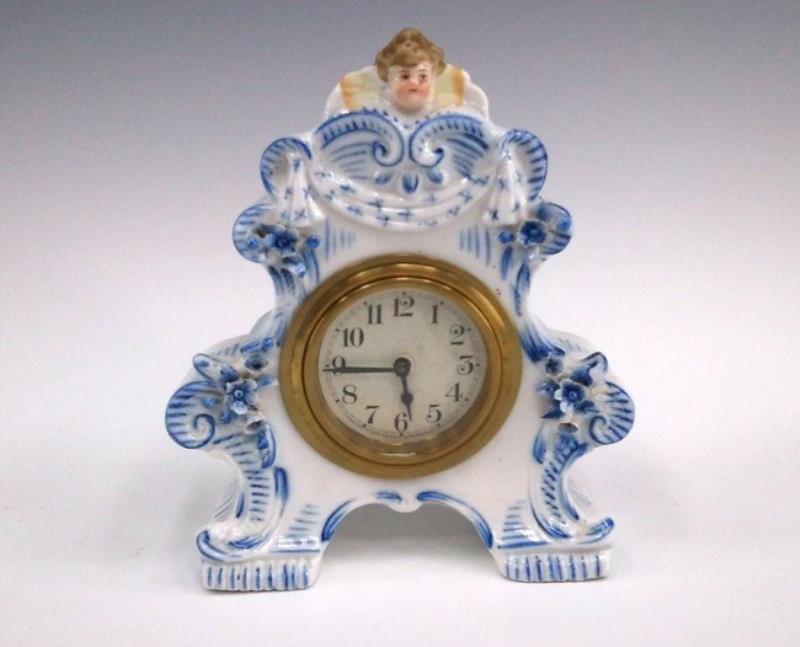 A CIRCA 1910 GERMAN PORCELAIN CLOCK W/ LUX MOVEMENT