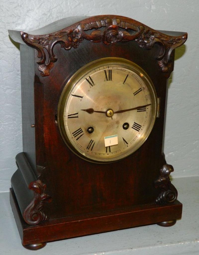 8 day walnut mantle clock w/rosette carving.