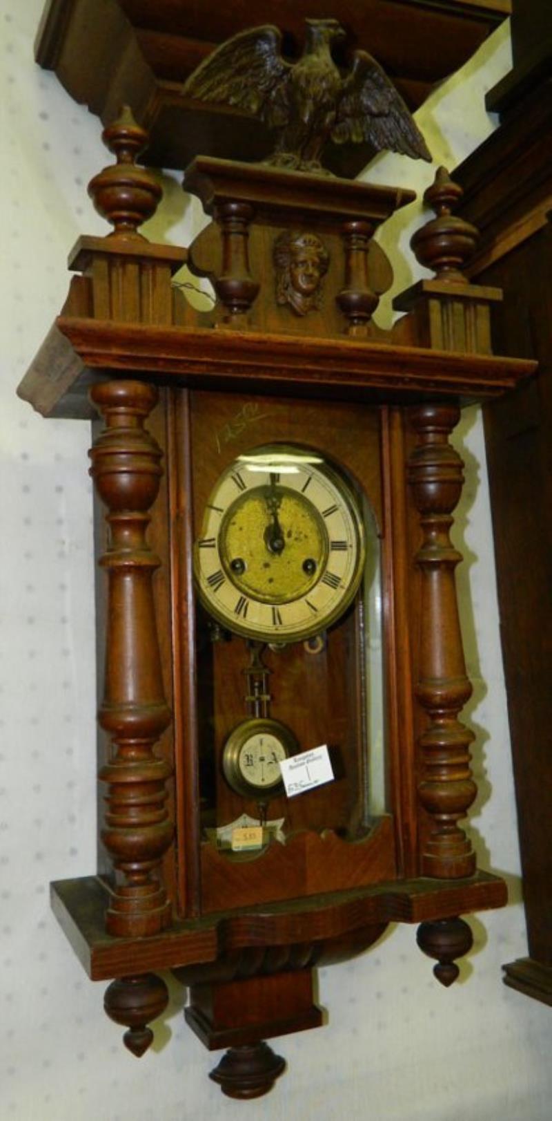 8 day mahogany case clock w/eagle detail.