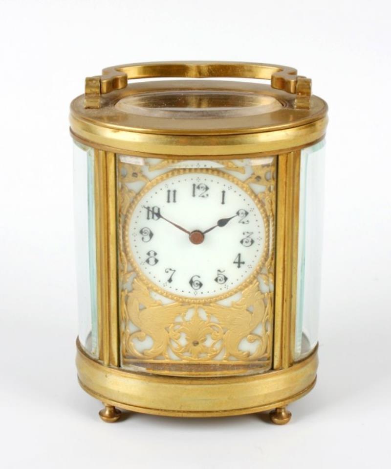 A brass oval carriage clock