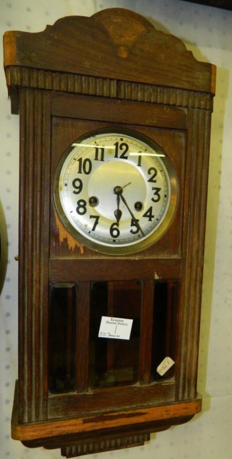 Oak 8 day wall clock w/silver painted dial.