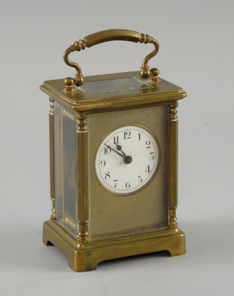Brass carriage clock in red leather carrying case. 15