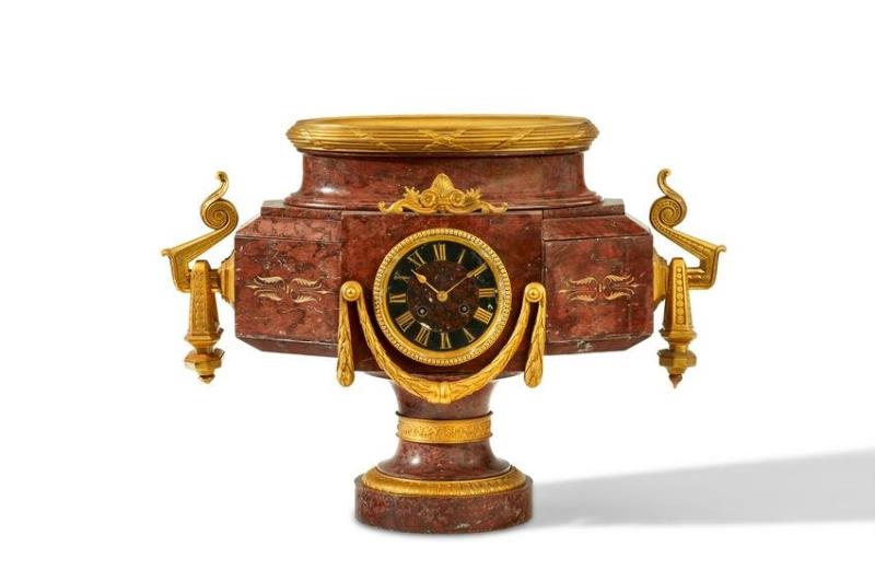 A rouge marble and bronze mantle clock