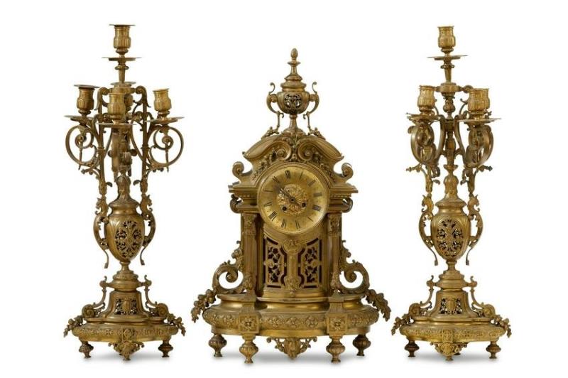 A French bronze mantel clock and candelabra