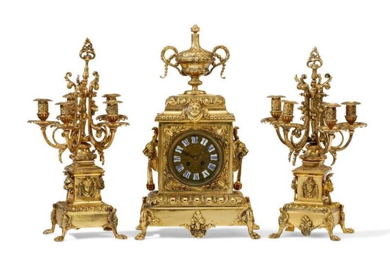 A French-style brass clock and candelabra set