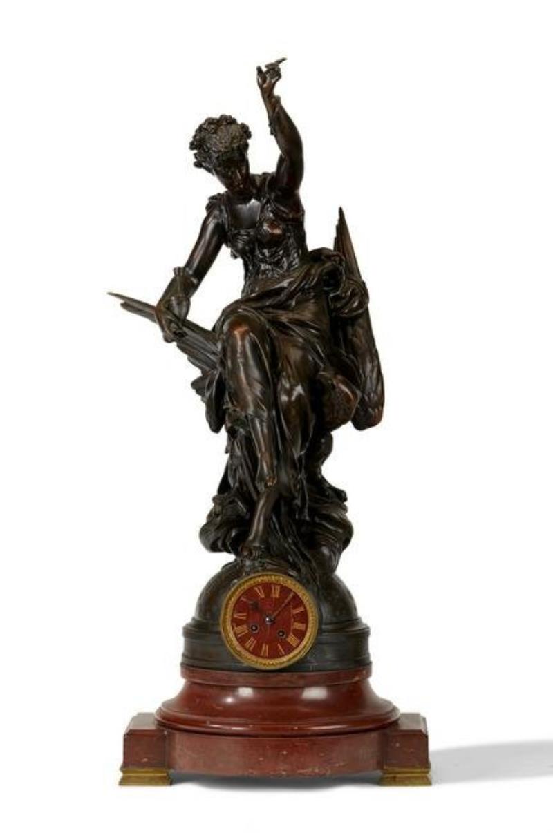 A French bronze and rouge marble figural clock