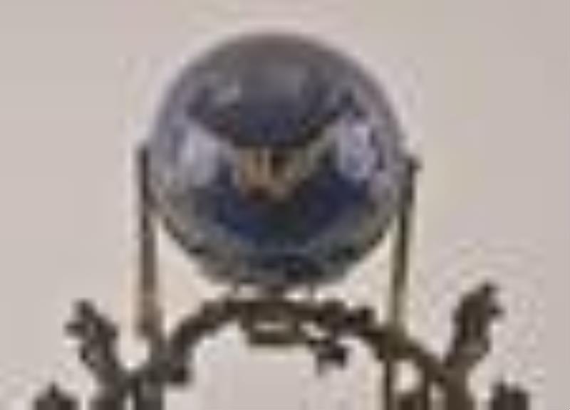 A turn of the 20th century couple on a swing figural mystery clock