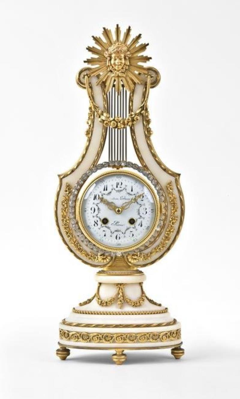 An early 20th century lyre form mystery clock with brilliant ring pendulum signed Festeau LeJeune