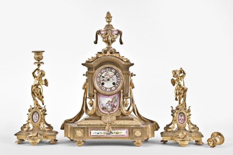 A late 19th century Louis XVI style clock garniture with decorative porcelain panels