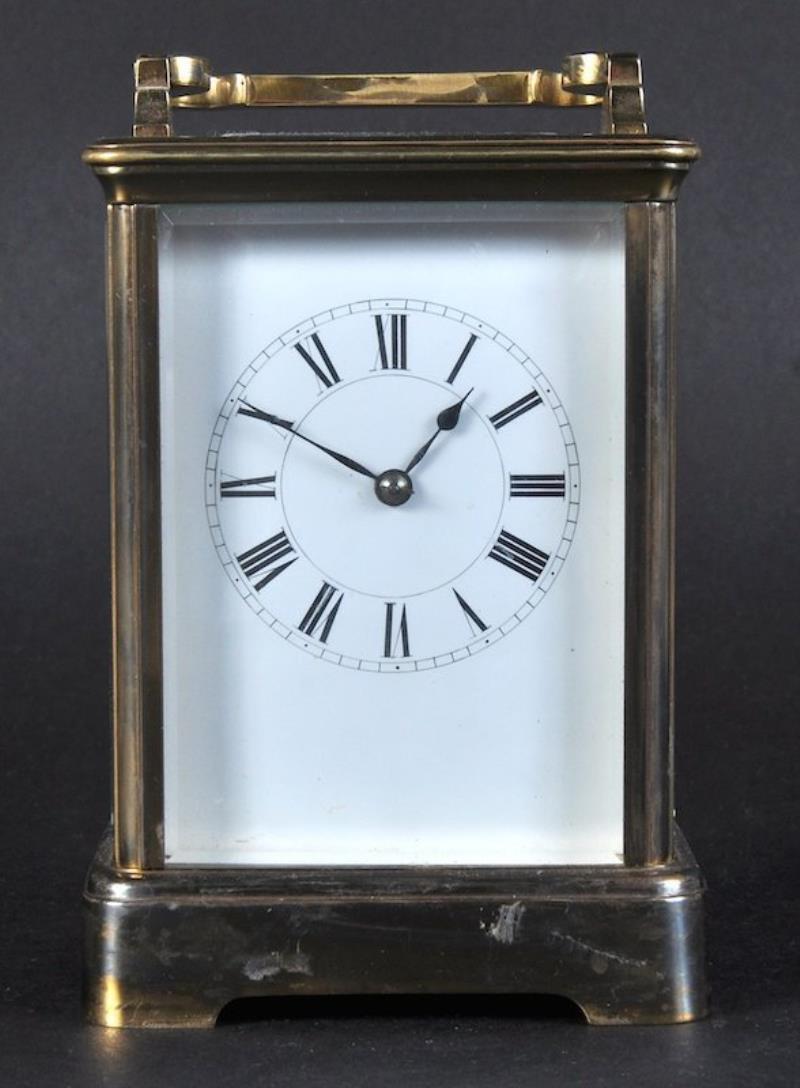 A BRASS STRIKING CARRIAGE CLOCK, 5 inches high.