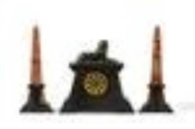 An Egyptian Revival mantel clock and garniture set