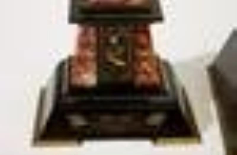 An Egyptian Revival mantel clock and garniture set