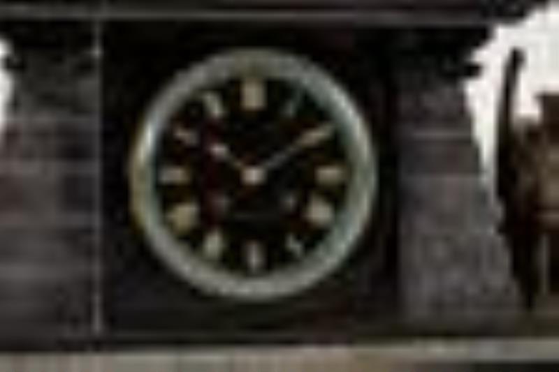 An Egyptian Revival bronze and marble mantel clock