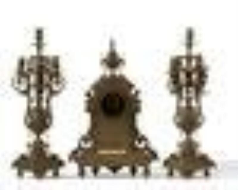 A French bronze mantel clock and candelabra