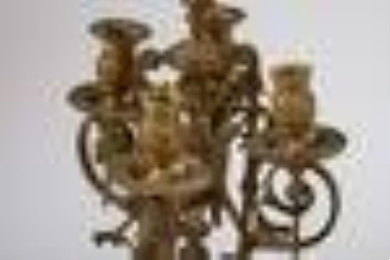 A French bronze mantel clock and candelabra