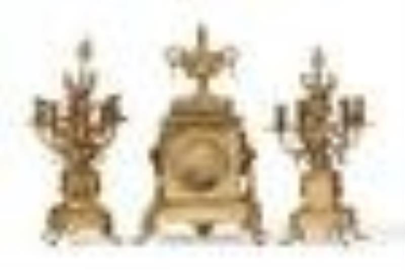 A French-style brass clock and candelabra set