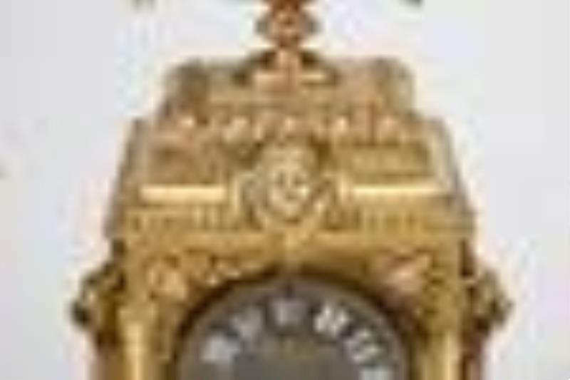 A French-style brass clock and candelabra set