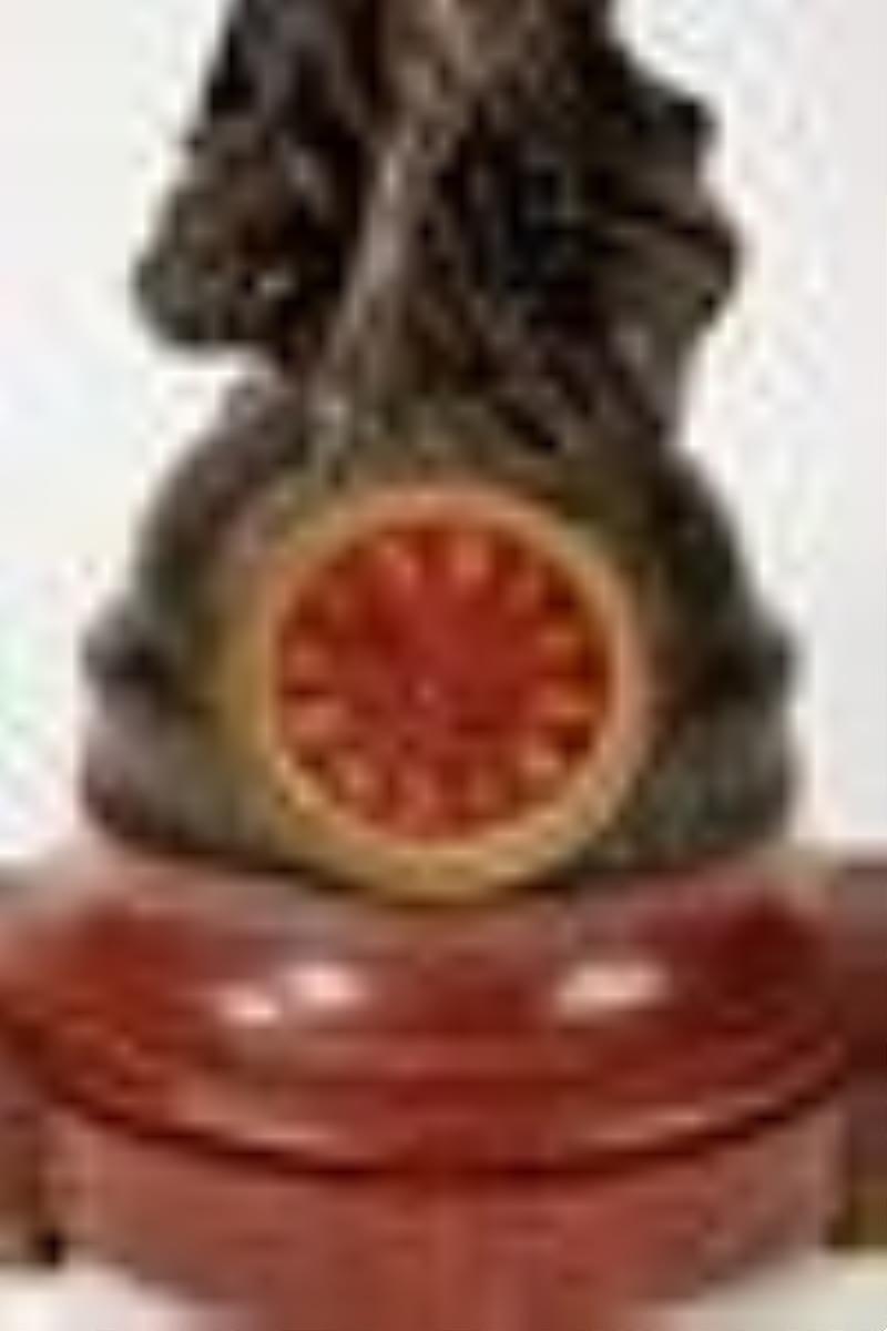 A French bronze and rouge marble figural clock