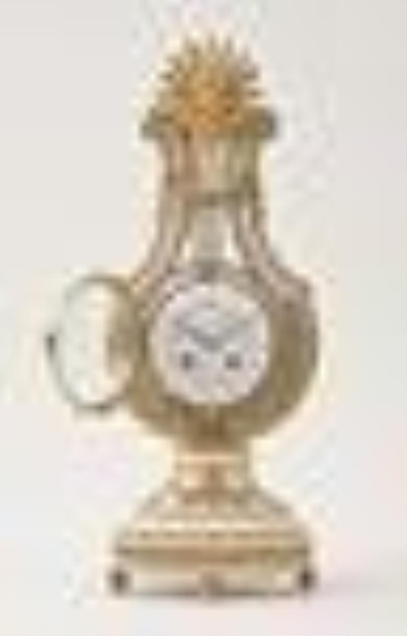 An early 20th century lyre form mystery clock with brilliant ring pendulum signed Festeau LeJeune