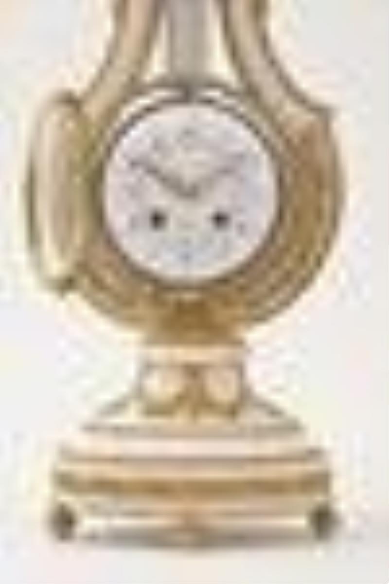 An early 20th century lyre form mystery clock with brilliant ring pendulum signed Festeau LeJeune