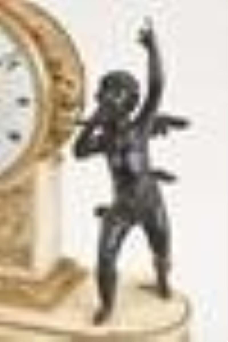 A late 18th century French bronze and marble figural mantel clock
