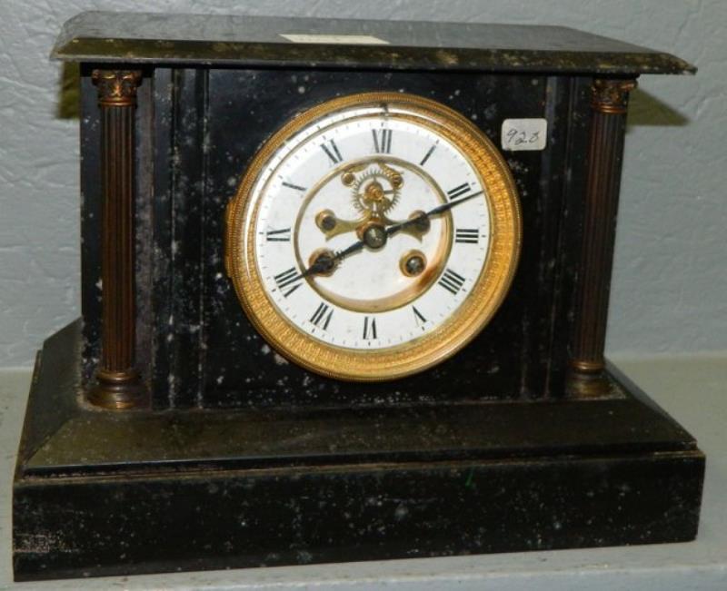 Marble 8 day shelf clock w/brass columns.