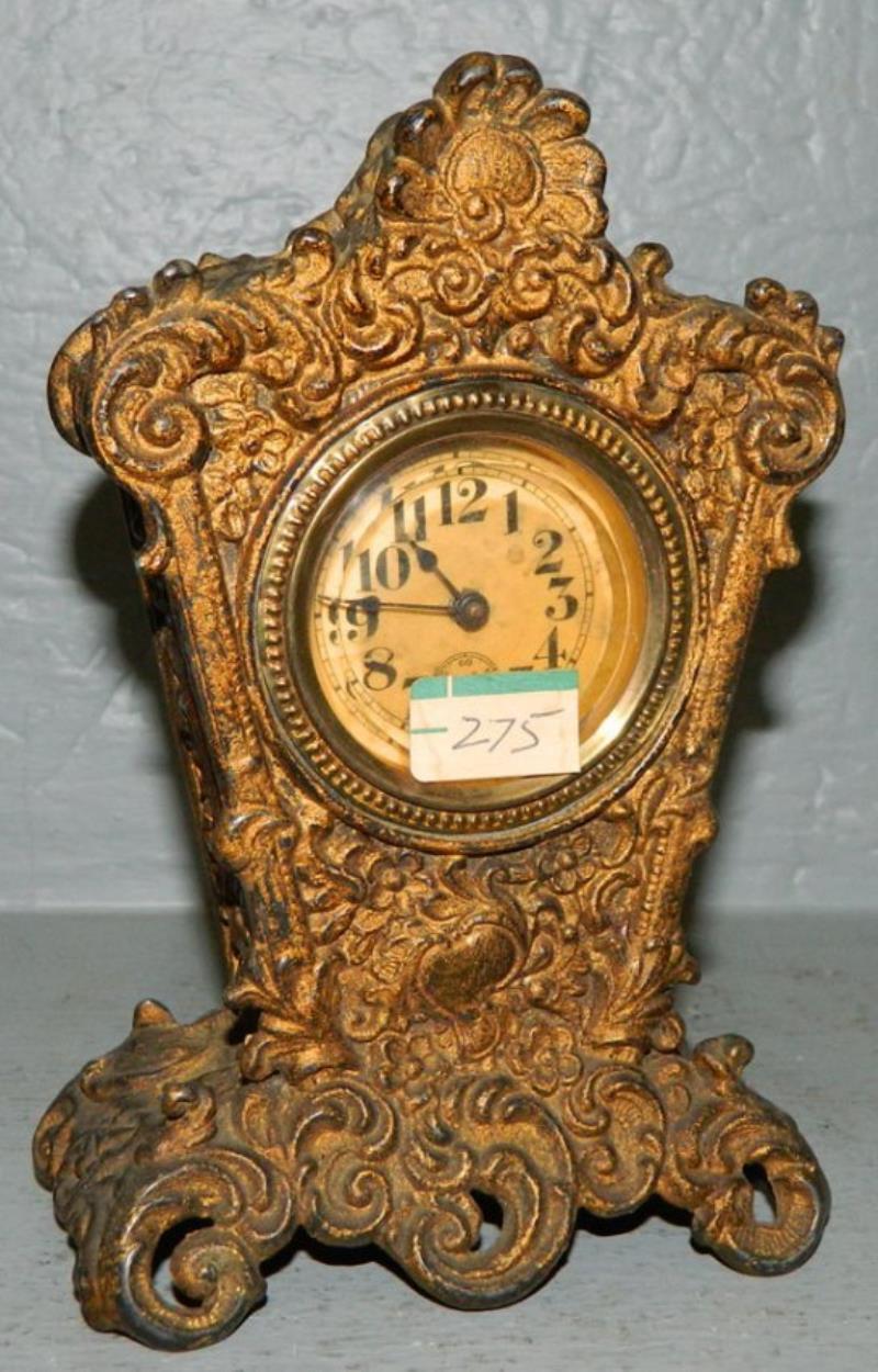 Embossed case gold painted 1 day clock.