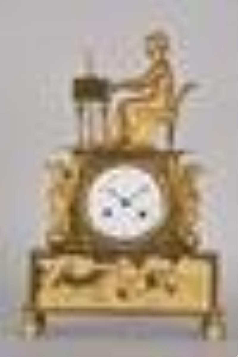 An attractive French Empire gilt bronze figural mantel clock