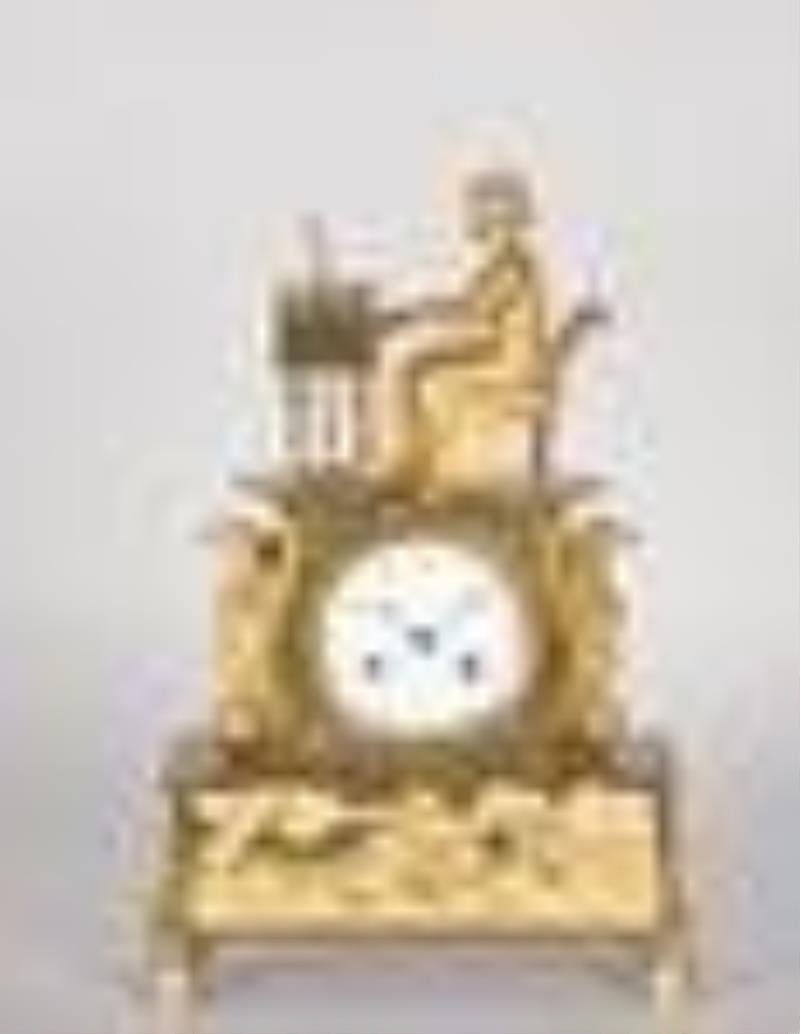 An attractive French Empire gilt bronze figural mantel clock