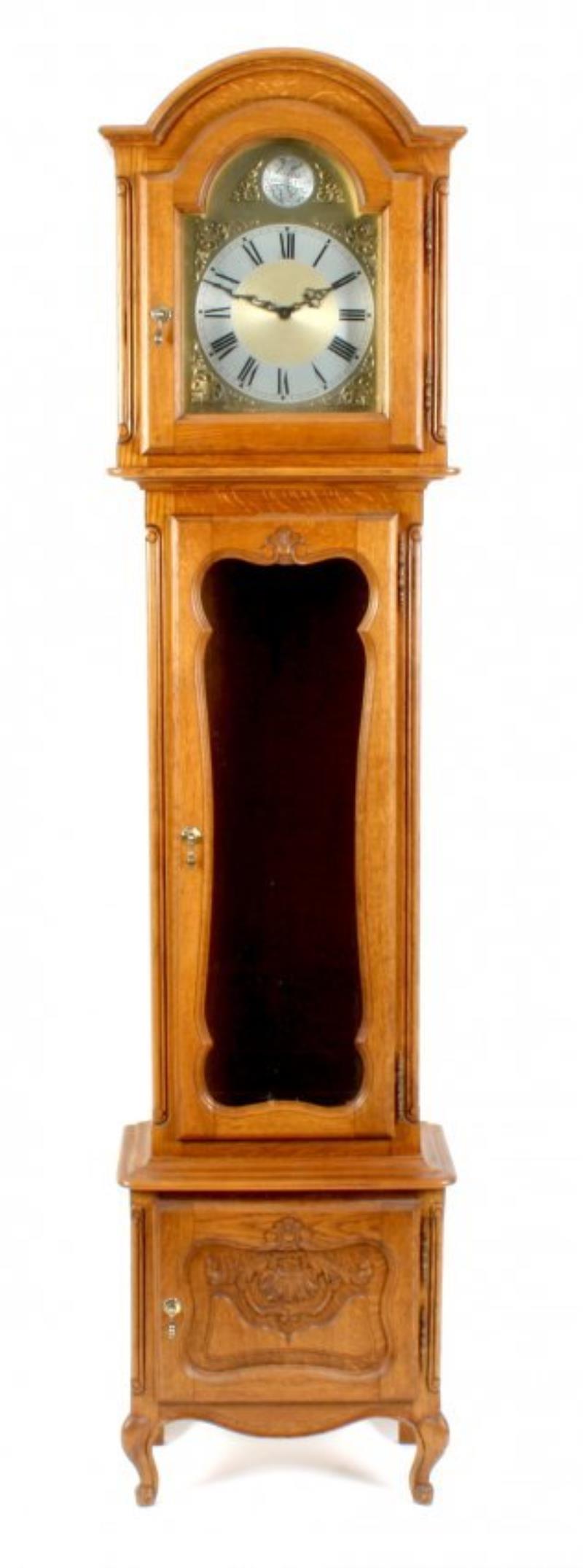 A modern oak-cased chiming long-case clock.