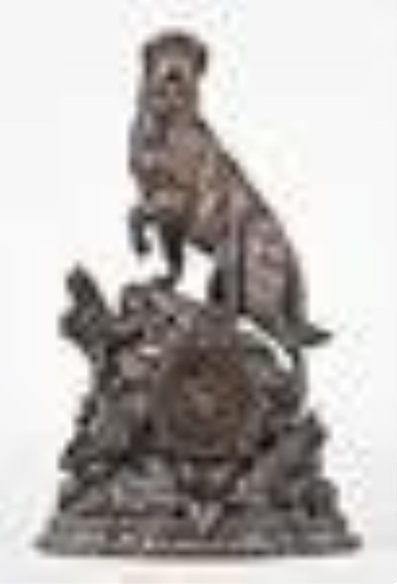A good turn of the 20th century carved figural Black Forest clock with St. Bernard