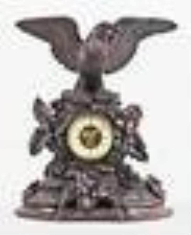 A good turn of the 20th century carved figural Black Forest clock with eagle