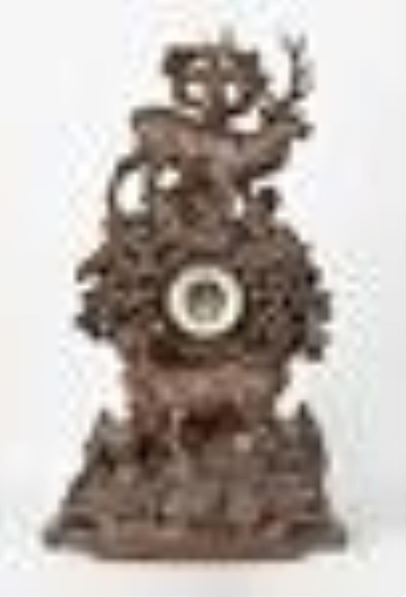 A monumental late 19th century Black Forest carved mantel clock
